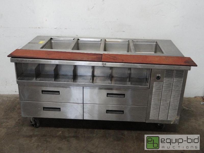 lot 1119 image: Stainless Four Bay Seam Table with Under Counter Refrigerated Four Door Storage
