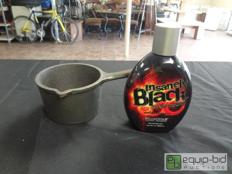 lot 87 image: Lodge Skillet and Tanning Lotion lol...