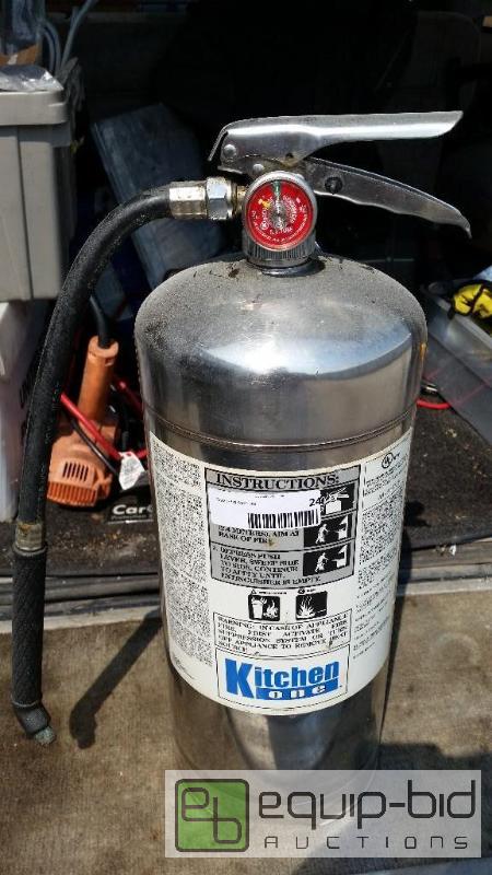 lot 7 image: Class K Stainless steel fire extinguisher.