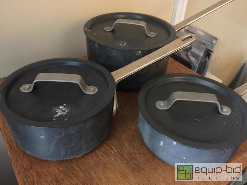 lot 87 image: Set of three commercial cookware pots with li...