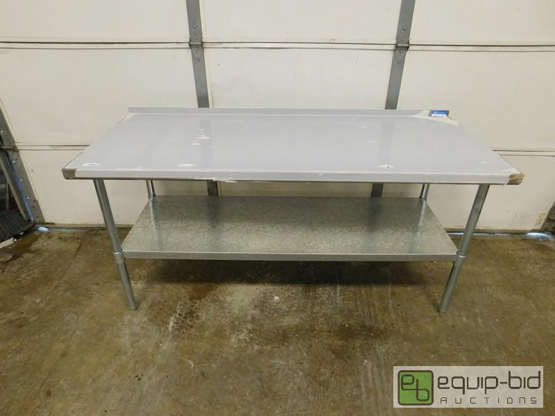 lot 440 image: New Scratch And Dent Stainless Steel Table With Undershelf And Riser