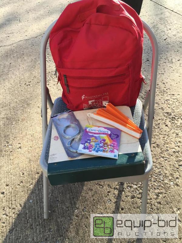 lot 207 image: Costco Folding Stool, Back Pack, Photo Albums, Hand Fan, Care Bear DVD Set