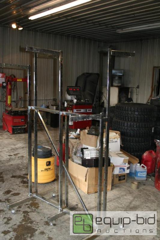 lot 2063 image: Metal clothing rack on casters. Adjustable fr...