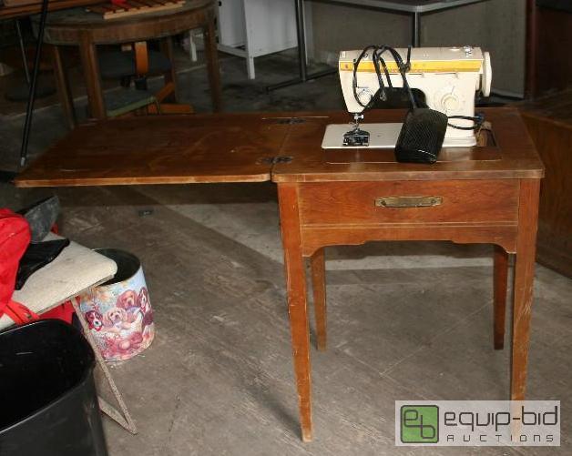 lot 2084 image: sewing machine and table. Machine is a Singer...