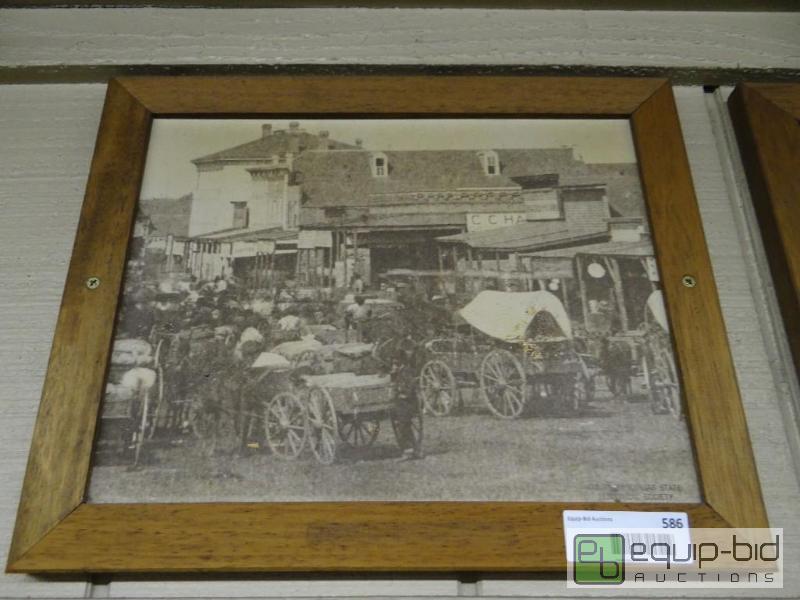 lot 586 image: Framed picture of Covered wagons in street in...