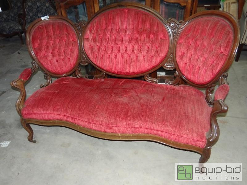 lot 656 image: Antique carved wood sofa.  One leg in back is...