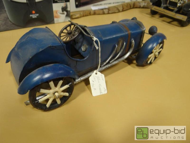 lot 725 image: Hand made metal blue roadster.  Marked $85...