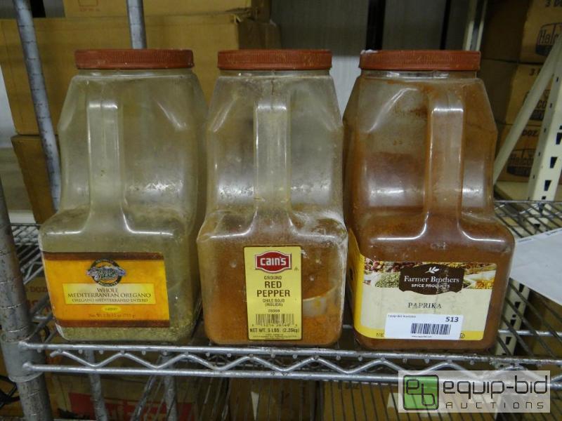 lot 513 image: 3 partial jugs of spices.  Oregano, red peppe...