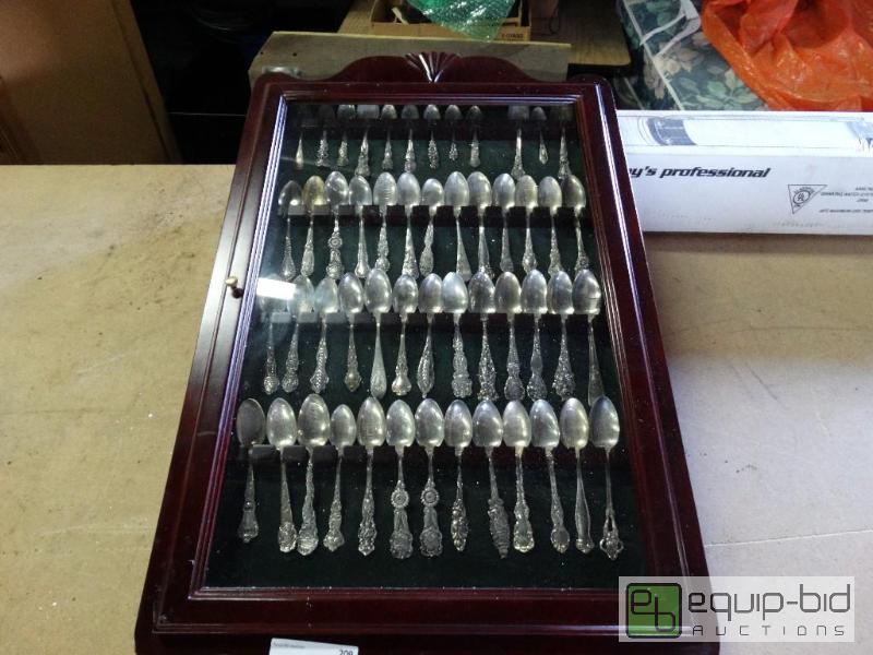 lot 209 image: Sterling silver spoon collection in glass fro...