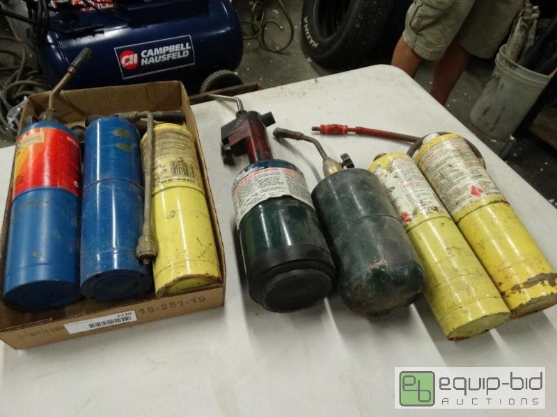 lot 1220 image: Torches and bottles....