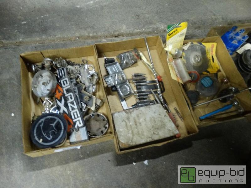 lot 1222 image: Drill bits , car emblems and car parts....