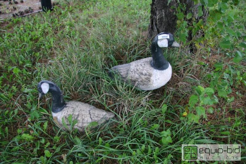 lot 104 image: Pair of cement geese statues....