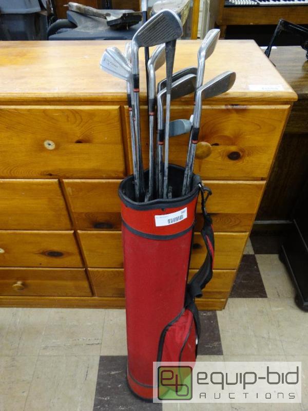 lot 562 image: Golf clubs and balls in red bag....