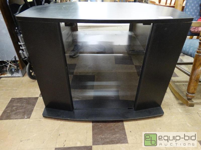 lot 576 image: Black media cabinet with glass front doors an...