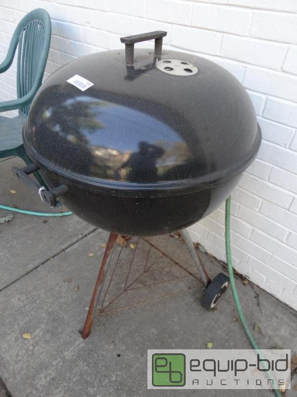 lot 2250 image: Round charcoal grill on wheels....